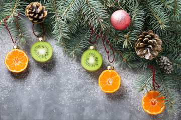 Christmas tree decorated with fruits of kiwi fruit and clementine. Healthy food and nutrition. Christmas decisions about a healthy lifestyle.