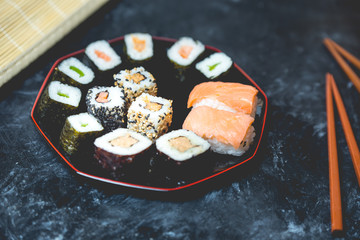 Japanese cuisine - sushi on a dark, stone background