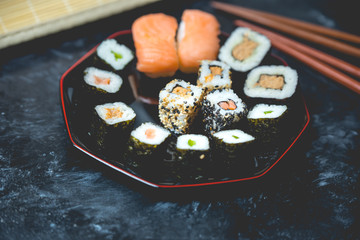 Japanese cuisine - sushi on a dark, stone background