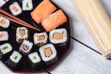 Japanese cuisine - sushi on a white, wooden background