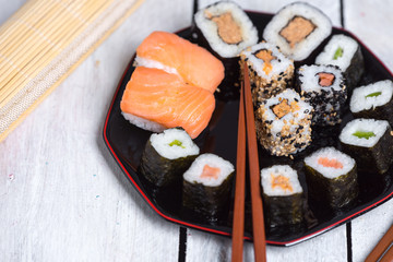 Japanese cuisine - sushi on a white, wooden background