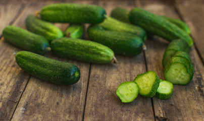 Fresh cucumbers on old wooden table