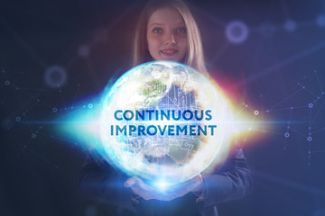 The concept of business, technology, the Internet and the network. A young entrepreneur working on a virtual screen of the future and sees the inscription: Continuous improvement