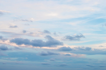 Naklejka na ściany i meble Evening light with clouds and blue sky.