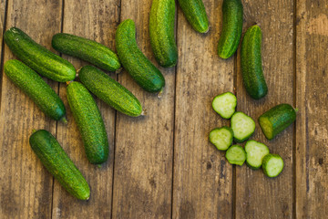 Fresh cucumbers on old wooden table
