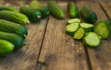 Fresh cucumbers on old wooden table