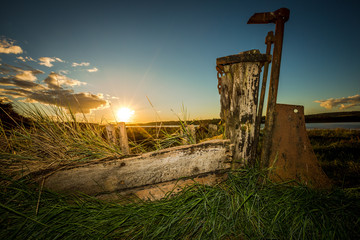 Obsolete small boats and barges were beached on the banks of the tidal River Severn in...