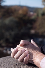 young man holding the hand of an old woman