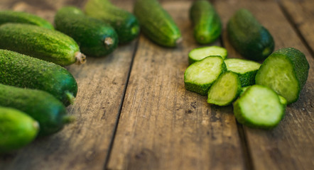 Fresh cucumbers on old wooden table