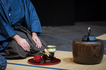 a man shows the tea ceremony during a public demonstration