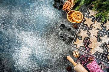 Merry Christmas background with traditional xmas gingerbread cookies, with decorations on grey marble background copy space