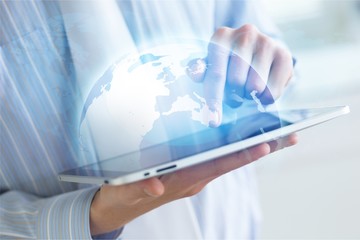 Man holding   digital tablet on background