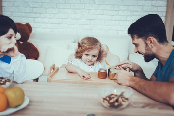 Fototapeta premium Father is Feeding His Sons a Breakfast