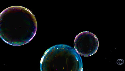 Obraz na płótnie Canvas Multicolored soap bubbles close up on a black background 