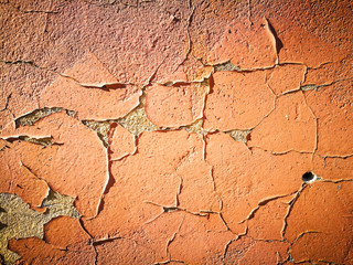 Old cracked wall with orange paint as background