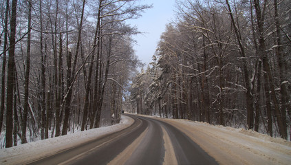 Fototapeta na wymiar Snow road in the forest in winter