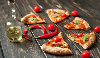 Fototapeta na wymiar pizza on wood table with ingredients