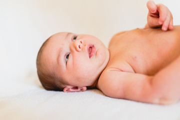 Portrait of newborn baby girl feels safe and awake to a new life.