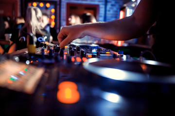 Dj playing disco house progressive electro music at the concert. DJ hands on equipment