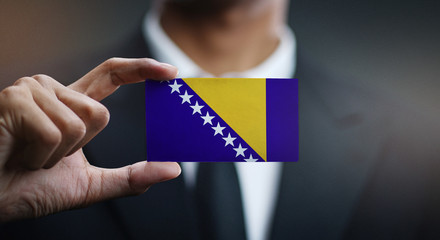 Businessman Holding Card of Bosnia and Herzegovina Flag