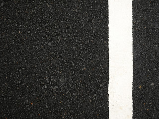 Black paved road background.