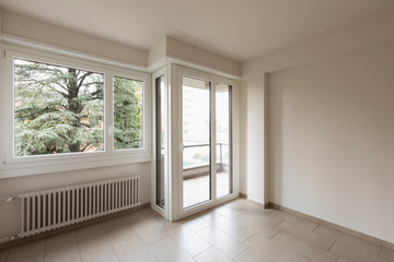 Empty room, large windows overlooking nature