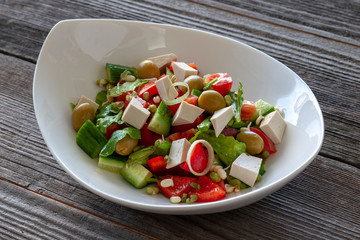 Vegetarian dish: Salad with Tofu cheese, with cucumbers, onions, sweet peppers, lettuce and sprouted seeds