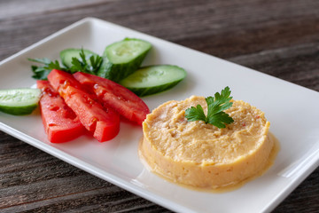 Hummus - a snack made from chickpea puree, which usually includes sesame paste, olive oil, garlic, lemon juice, paprika.