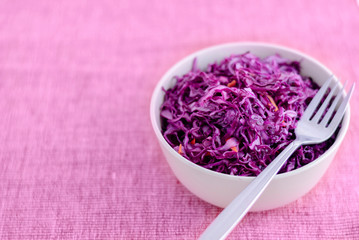 Obraz na płótnie Canvas Fork on bowl with purple sauerkraut