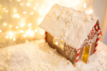 Christmas and New Year greeting card. Christmas concept. gingerbread house on the background of garlands