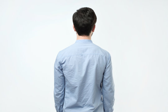 Young Man In Blue Shirt Standing Alone Back Side View