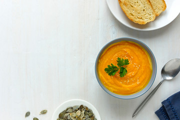 Bowl of pumpkin soup served with seeds