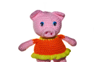 Knitted handmade pink pig on the isolated white background