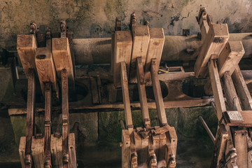 The mechanism of the old paper mill - pressing and crushing with wooden hammers © andrey gonchar