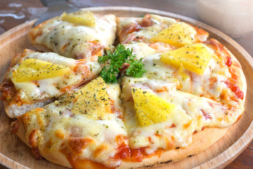 close up of Hawaiian pizza juicy pineapple chunks ham bits melted mozzarella cheese