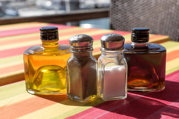 Salt, Pepper, olive oil and balsamic vinegar on restaurant table