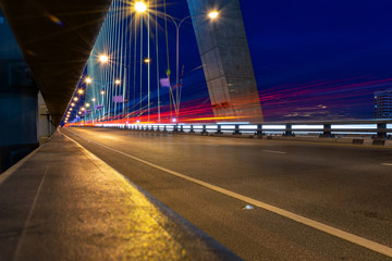 Fototapeta na wymiar Long exposure traffic lights on the bridge, traffic in the city at night