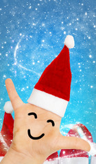 Santa Claus, hand with Santa hat and face in front of Christmas hats and snow flurries