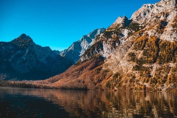 Fototapeta na wymiar Beautiful autumn reflections at the famous Koenigssee-Bavaria-Germany