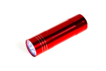 Red aluminum LED flashlight, isolated on white. Close-up