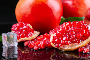 Ripe pomegranate fruits on the wooden background