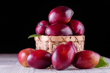 Fototapeta na wymiar Sweet plums on wooden background