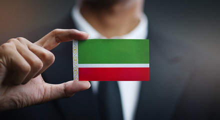 Businessman Holding Card of Chechen Republic Flag