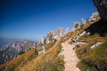 Panoramic view of the towers and spiers of the southern Grigna from the direct route, on a sunny autumn day.