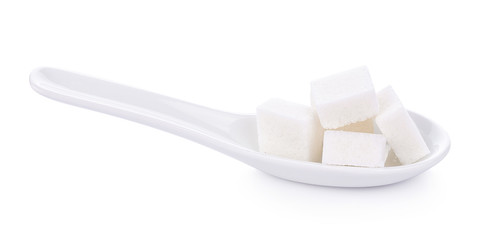white sugar cube in spoon on white background