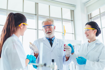 Fototapeta premium Science teacher and students team working with chemicals in lab
