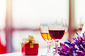 Two wineglass and red gift box setting object party on teble