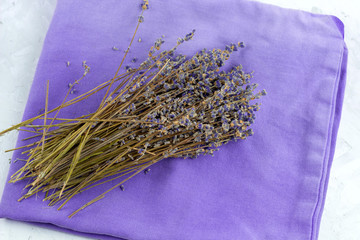 top view dry lavender flowers on a violet napkin