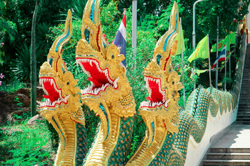 The art of Thai culture, stucco, green Naga decorated by the roof of church and stairs of the...