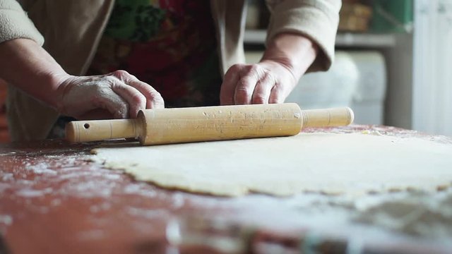 Woman lays out the rolled dough on a baking sheet